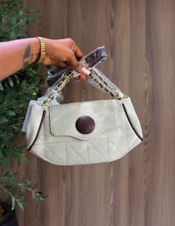 Hands holding a grey bag