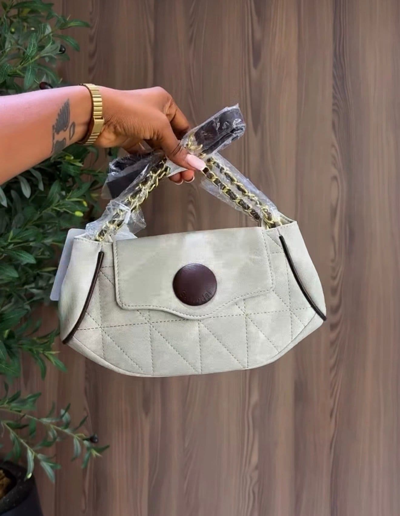 Hands holding a grey bag