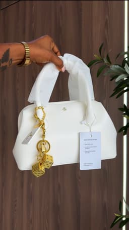 Hands holding a white bag