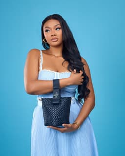 Model holding a black bag